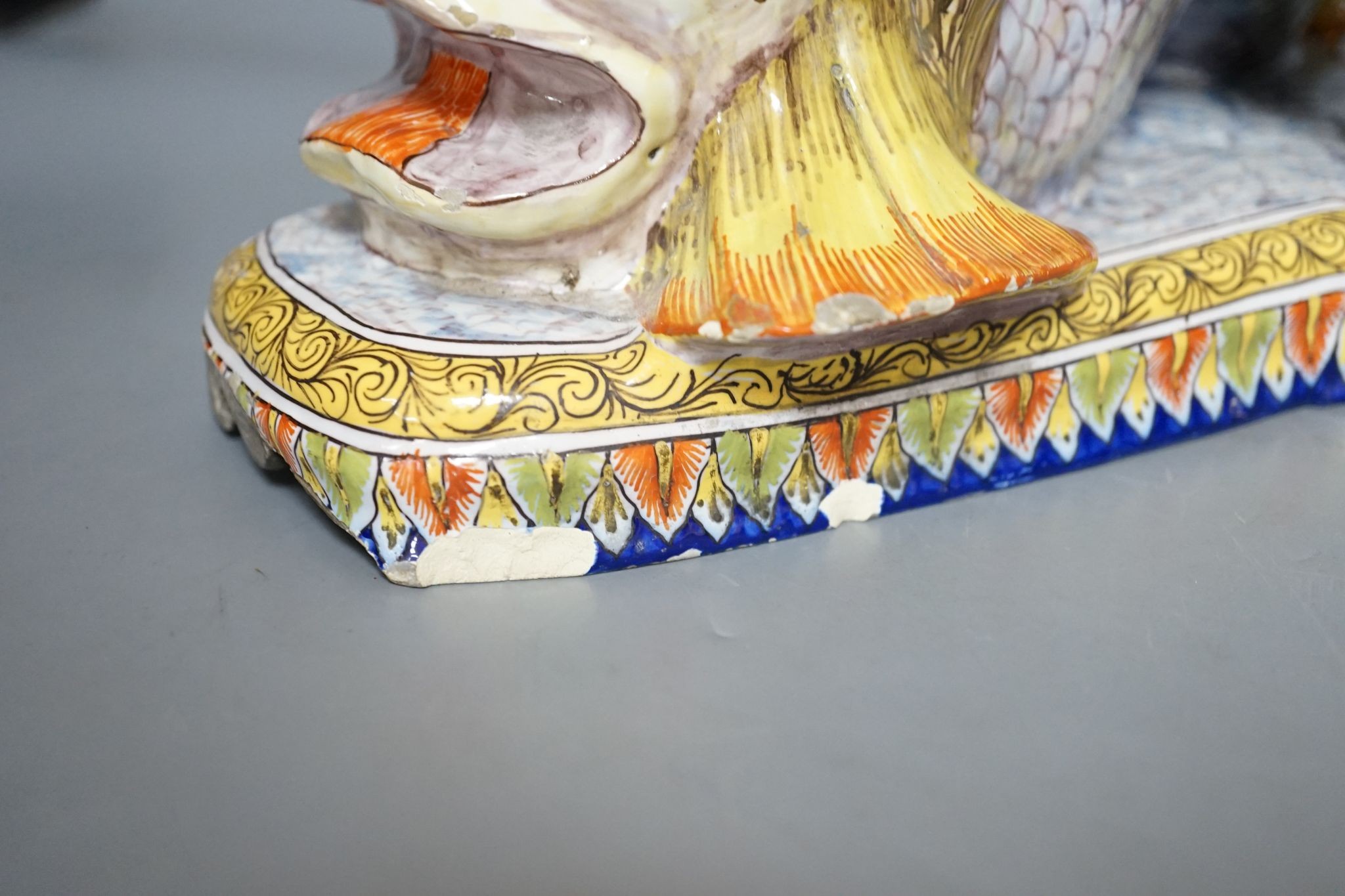 An 18th century Venetian maiolica ‘dolphin’ base and associated blush ivory cherubic figural bowl, 36cm